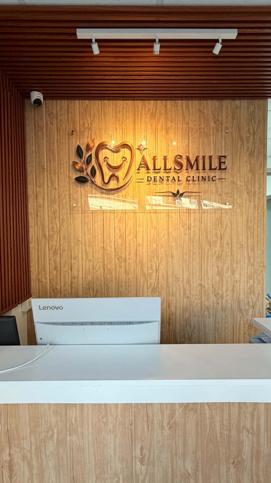 AllSmile Dental Clinic reception desk and logo wall