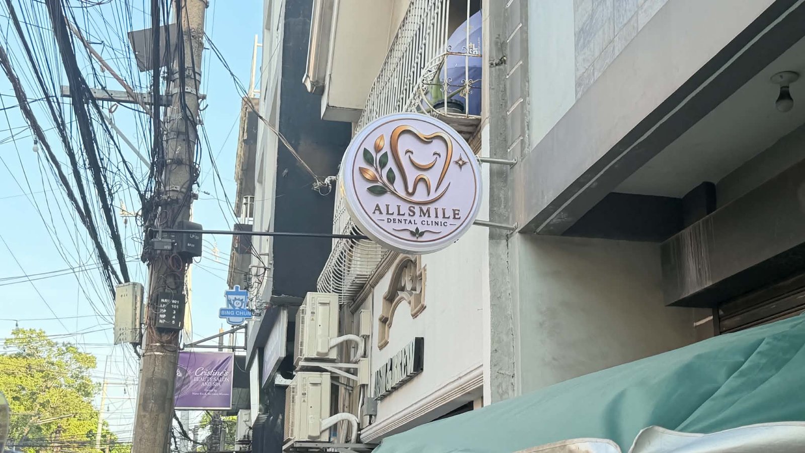 AllSmile Dental Clinic hanging street signage
